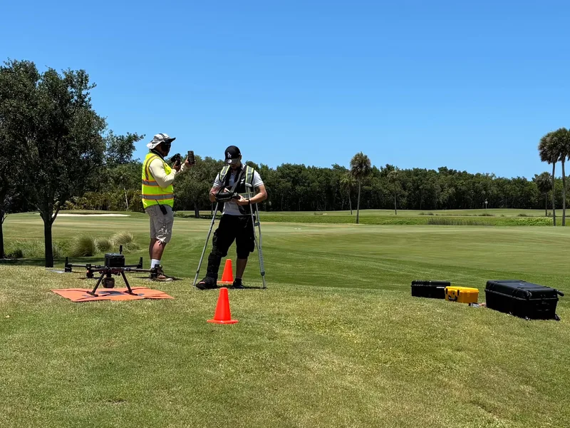 SurveyFy drone crew with a LiDAR drone and GNSS base on a golf course survey