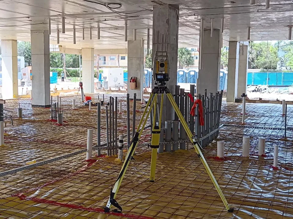 Total station set up on an active construction pour deck