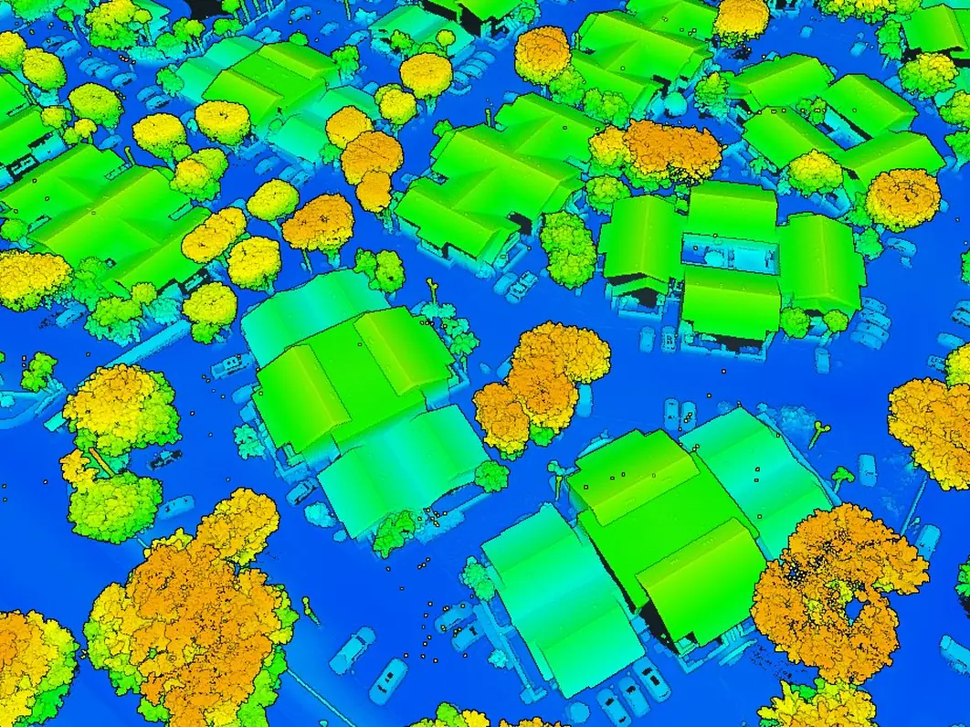 LiDAR point cloud of a residential neighborhood with roofs and tree crowns colored by height