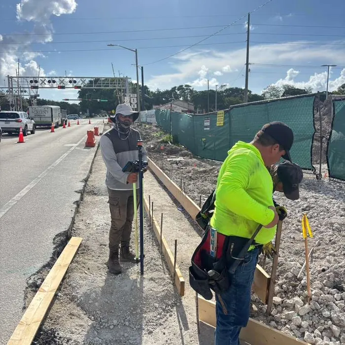 SurveyFy crew measuring a curb and sidewalk under construction