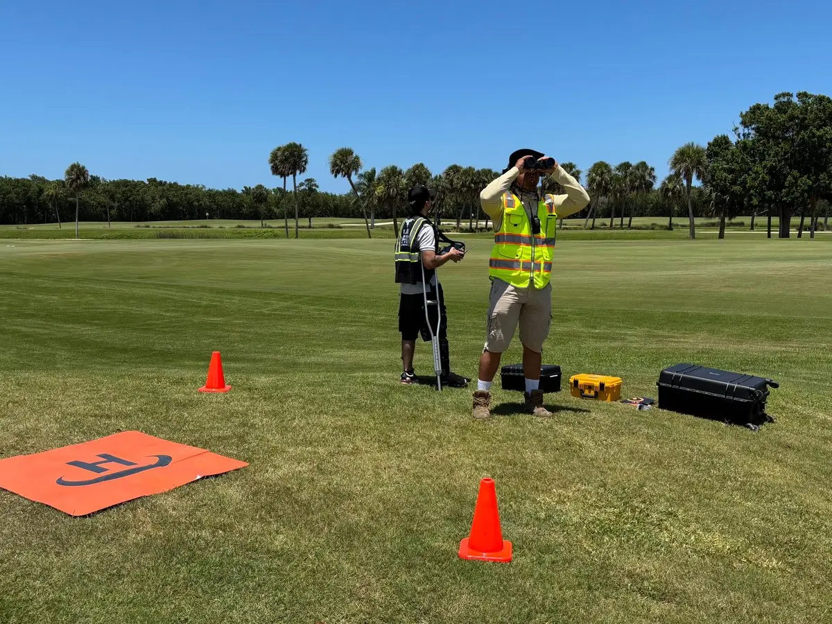 SurveyFy crew launching a drone on an open field in Florida