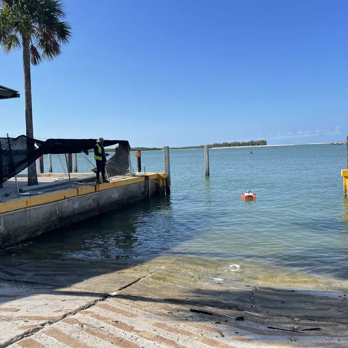 Orange hydrographic survey drone at a boat ramp in Florida