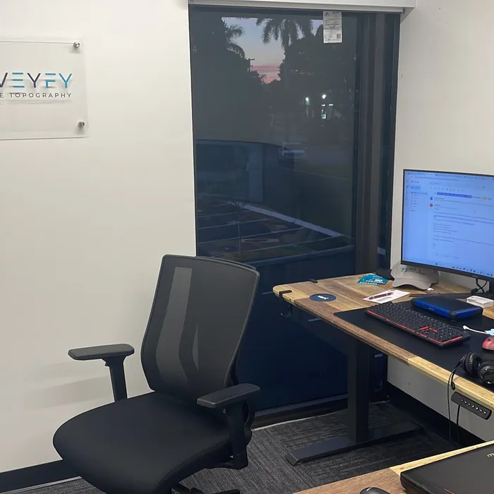 SurveyFy office with workstations and the company logo
