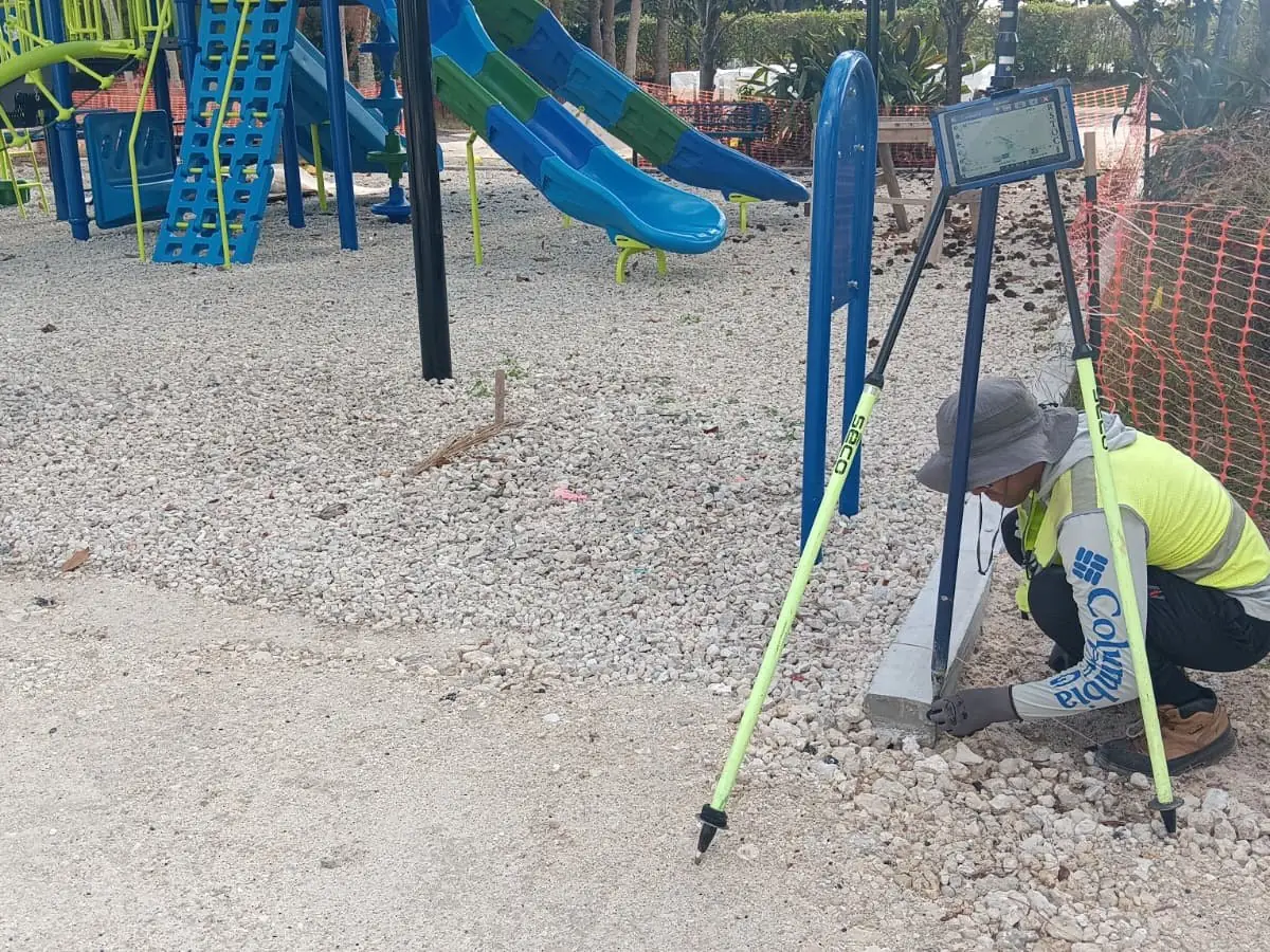SurveyFy surveyor with a total station at a park in Florida